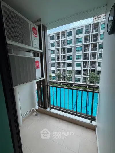 Charming balcony with pool view in modern apartment complex