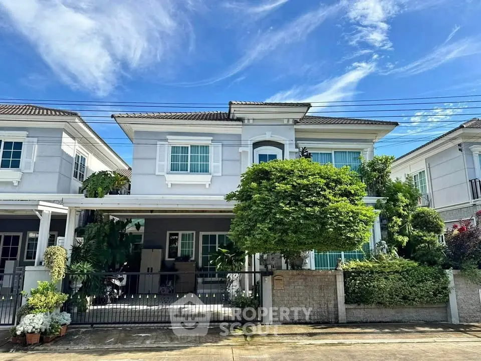 Stunning two-story house with lush greenery and modern facade in a serene neighborhood.