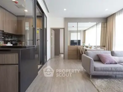 Modern open-plan living room with sleek kitchen and cozy dining area.