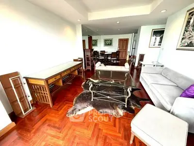Spacious living room with elegant wooden flooring and modern furniture