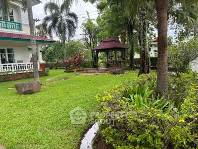 Charming garden with gazebo and lush greenery in a serene residential setting
