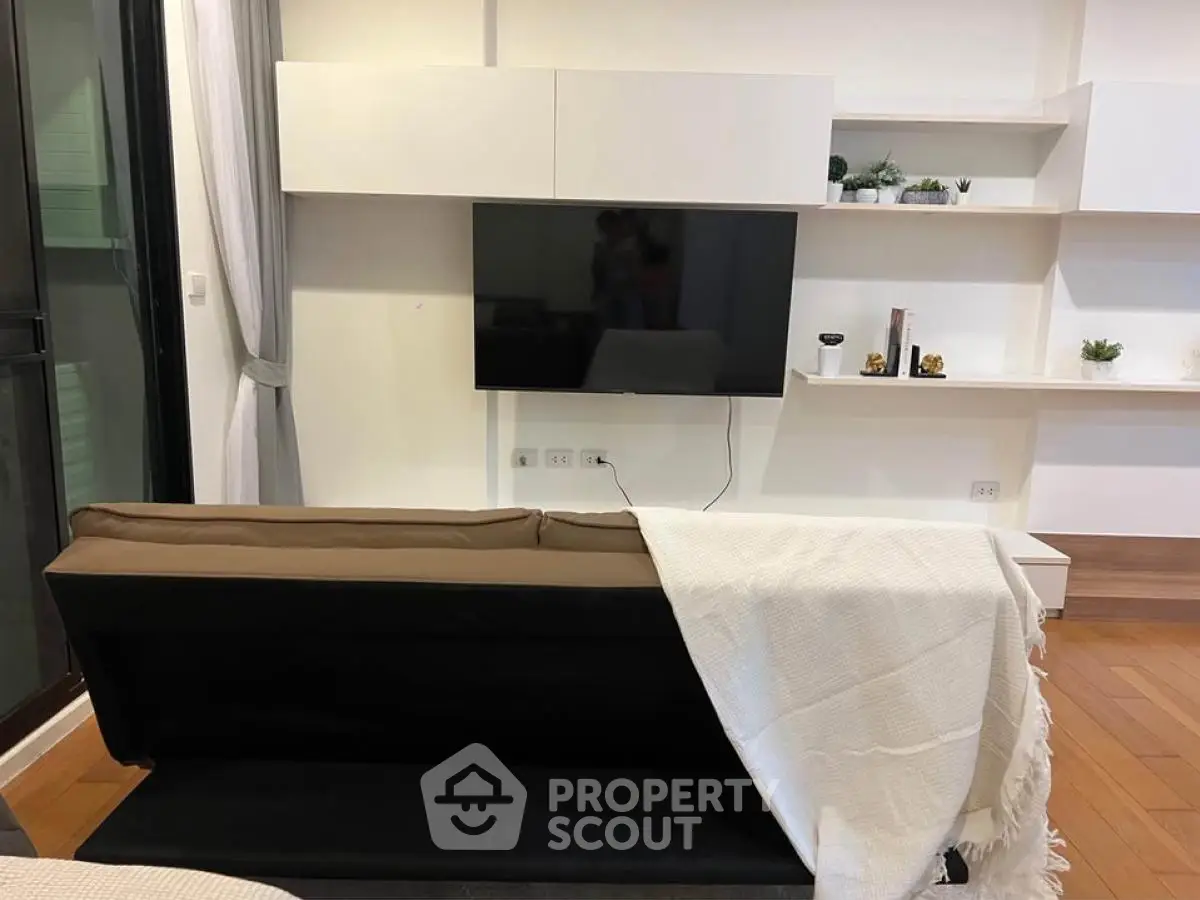 Modern living room with sleek TV setup and stylish shelving