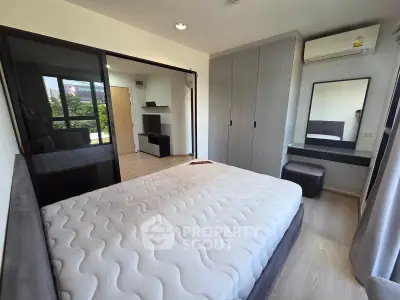 Modern bedroom with large bed, mirrored wardrobe, and air conditioning in a stylish apartment.