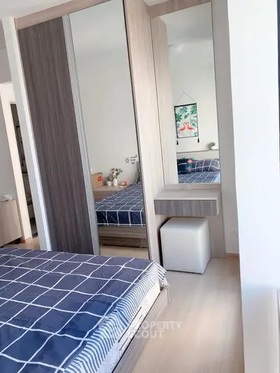 Modern bedroom with stylish mirrored wardrobe and cozy decor