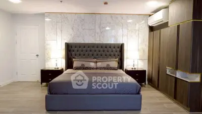 Luxurious bedroom with elegant decor and modern furnishings, featuring a plush bed and stylish lighting.