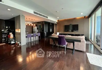 Spacious modern living room with open kitchen and elegant hardwood floors