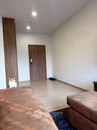 Modern living room with cozy brown sofa and stylish wooden accents.