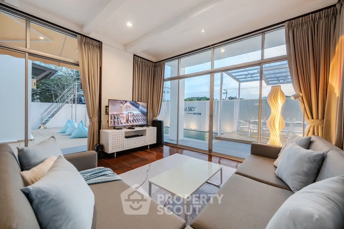 Spacious modern living room with large windows and stylish decor