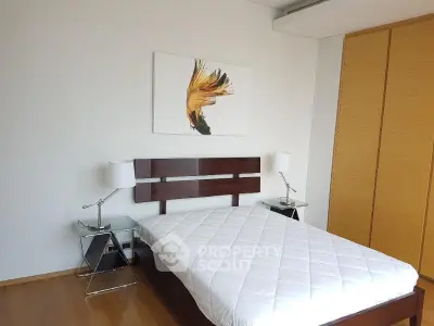 Modern bedroom with stylish decor and wooden accents, featuring a comfortable bed and sleek bedside tables.