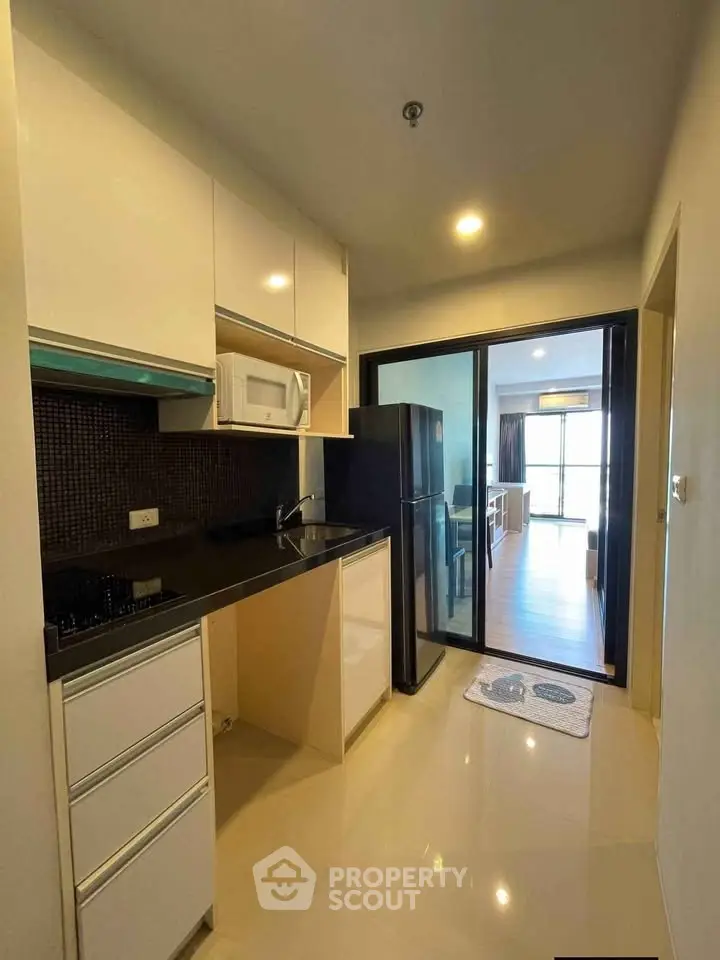 Modern kitchen with sleek cabinetry and appliances in a stylish apartment