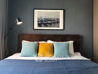 Stylish bedroom with modern decor and cozy pillows, perfect for relaxation.