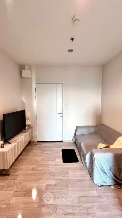 Modern living room with sleek TV setup and cozy sofa, perfect for relaxation.