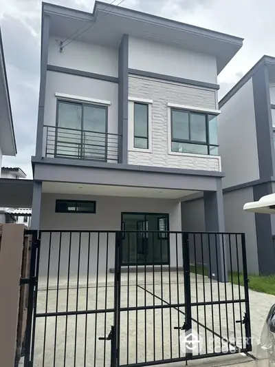 Modern two-story house with sleek design and gated driveway