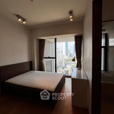 Modern bedroom with city view and natural light