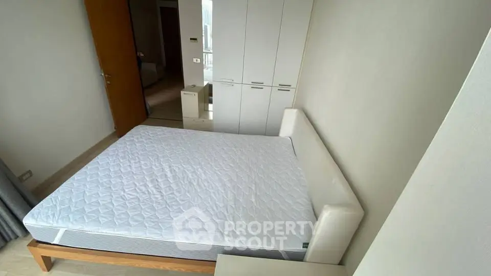Spacious bedroom with modern wardrobe and comfortable bed in a bright apartment.