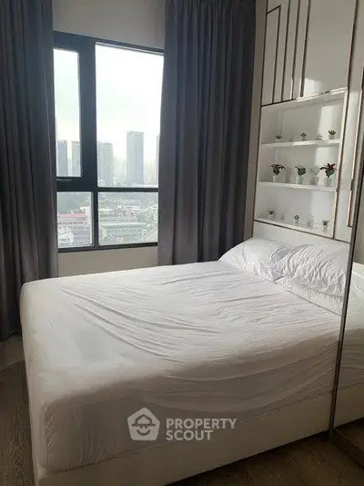 Modern bedroom with large window and city view, featuring sleek design and ample natural light.