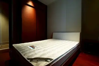 Cozy bedroom with a comfortable mattress and warm lighting, perfect for restful nights.