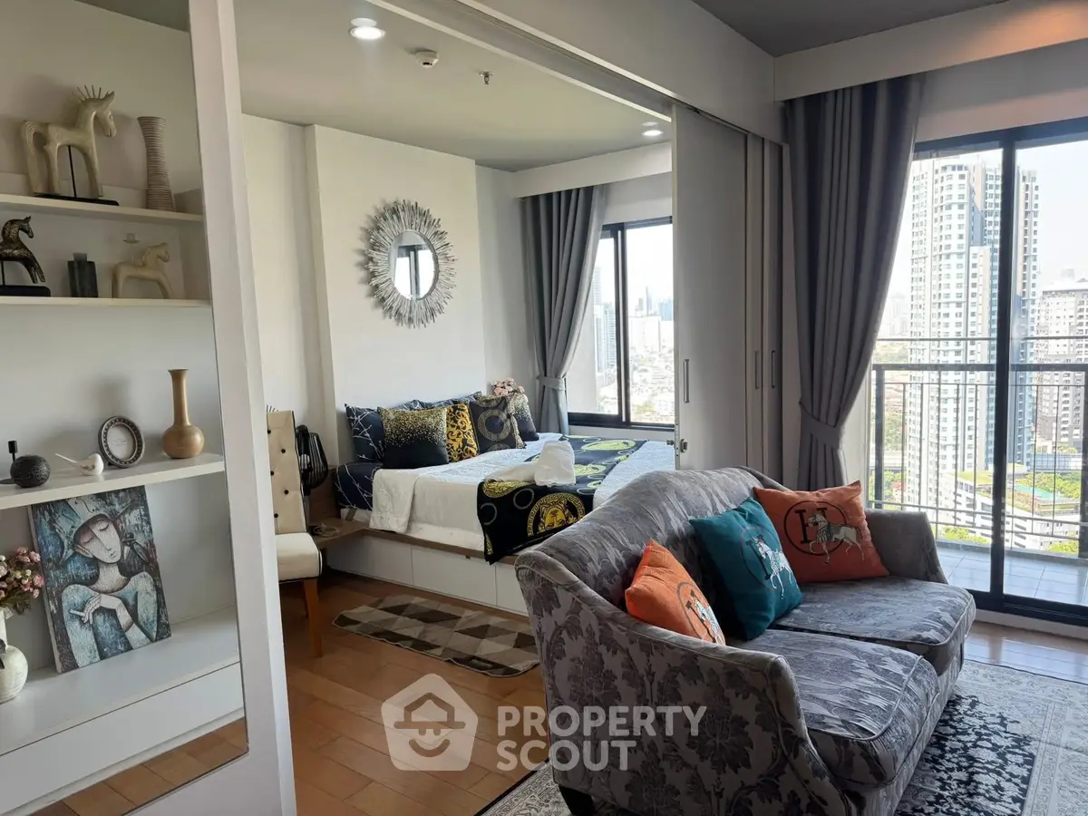 Chic urban apartment with stylish living room and bedroom, featuring city skyline views and modern decor.