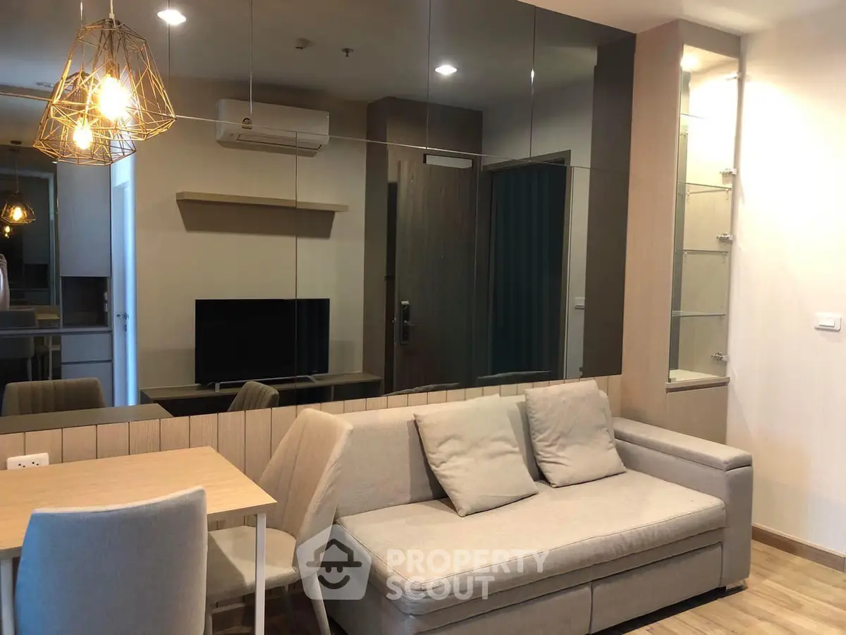 Modern living room with stylish decor, cozy sofa, and elegant lighting in a contemporary apartment.