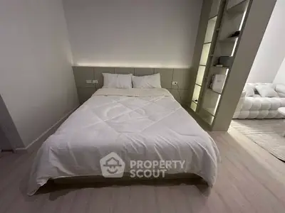 Modern bedroom with cozy bed and stylish shelving unit