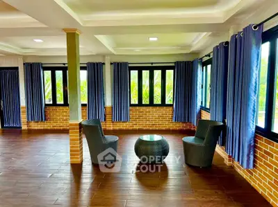 Spacious living room with large windows and elegant decor