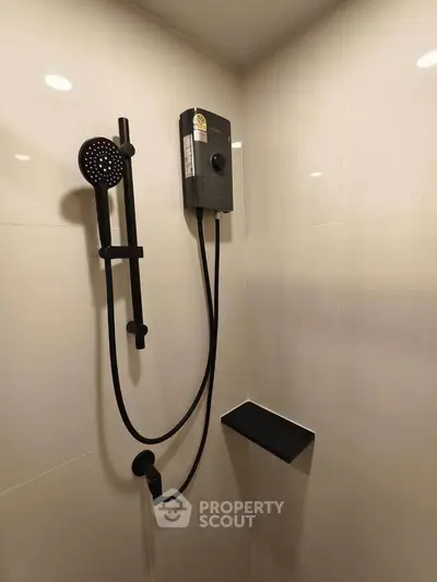 Modern bathroom shower with sleek black fixtures and built-in shelf