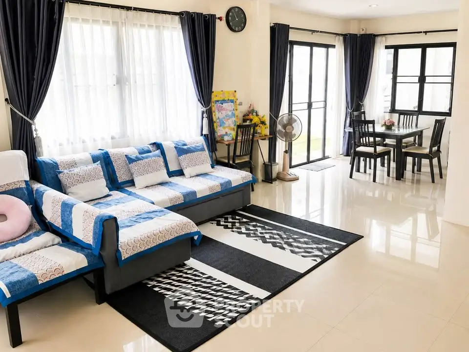 Spacious living room with modern decor and large windows for natural light.