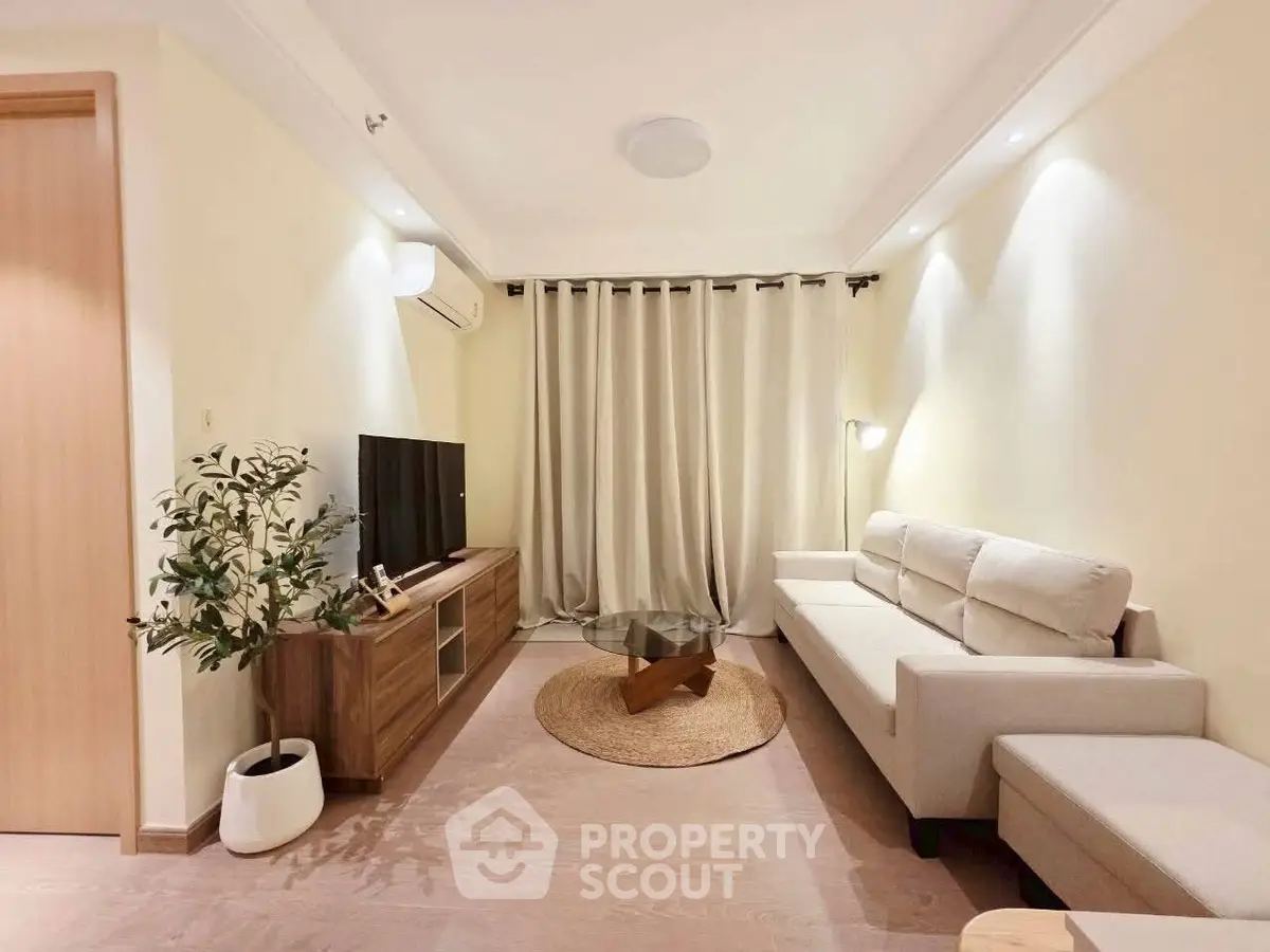 Modern living room with cozy beige sofa and stylish wooden TV stand