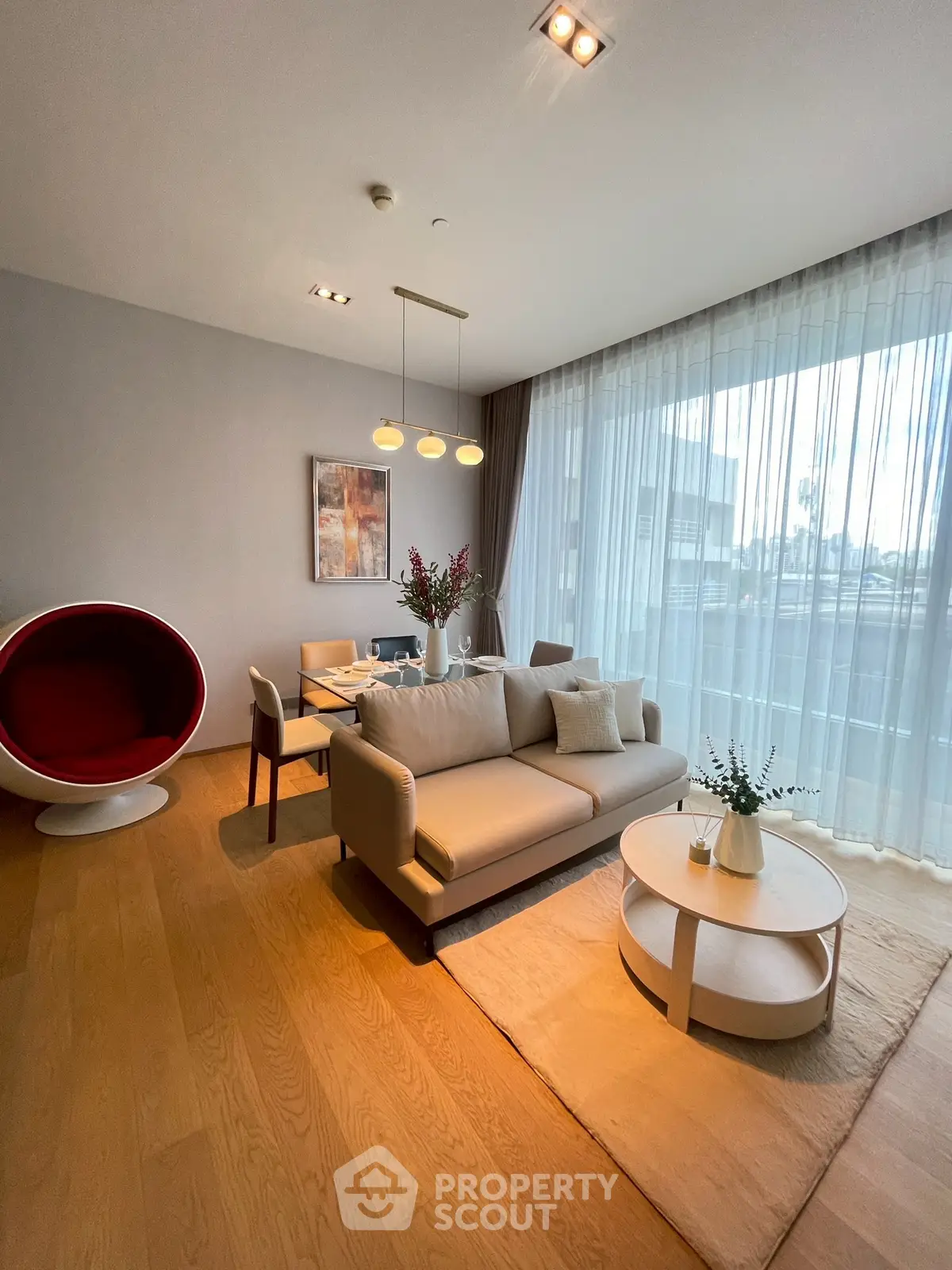 Modern living room with stylish furniture and large window view