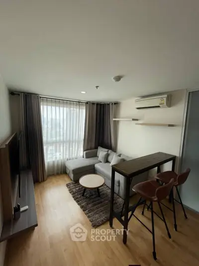 Modern living room with cozy sofa, stylish bar table, and large window with city view.