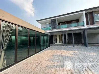 Modern two-story house with spacious courtyard and glass facade