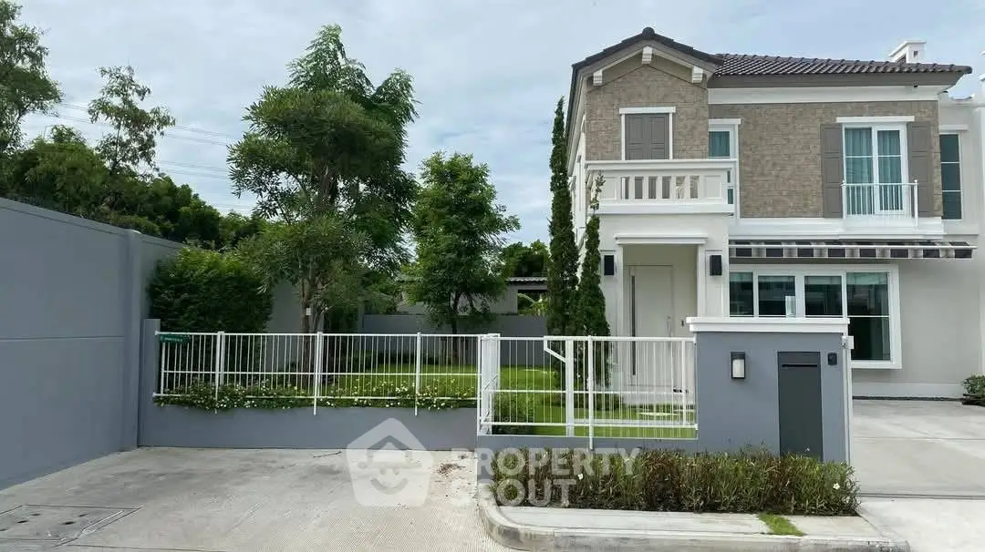 Charming two-story house with lush garden and modern exterior design