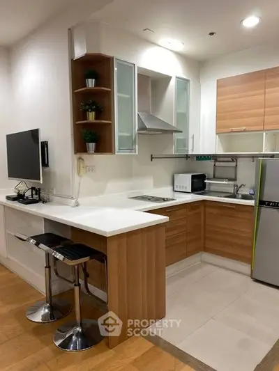 Modern kitchen with sleek wooden cabinets and breakfast bar in stylish apartment