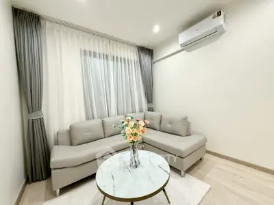 Modern living room with elegant gray sofa and air conditioning