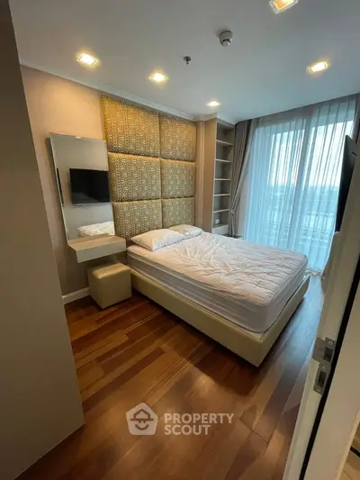 Luxurious bedroom with elegant decor and large window offering natural light and stunning views.