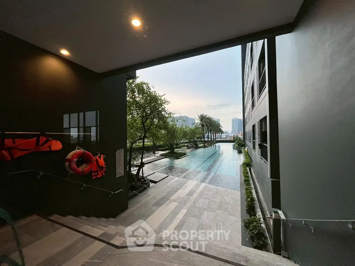 Luxurious poolside view with modern architecture and lush greenery