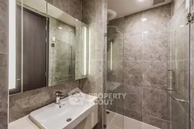 Luxurious modern bathroom with elegant marble tiles and glass shower enclosure