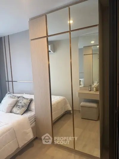 Modern bedroom with mirrored wardrobe and cozy decor