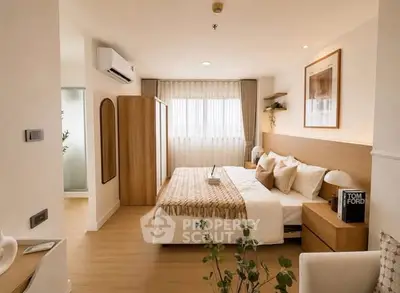Elegant bedroom with modern decor and natural light, featuring a cozy bed and stylish furnishings.