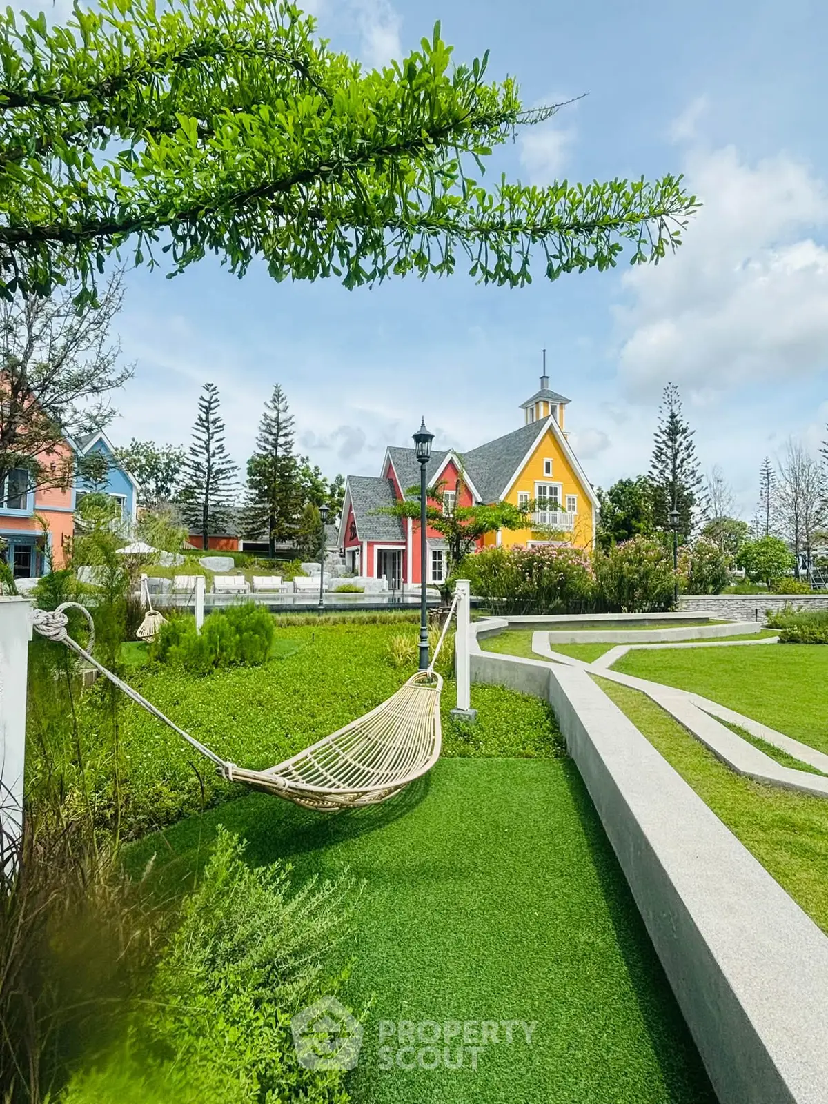 Charming garden view with colorful houses and hammock, perfect for relaxation and outdoor enjoyment.