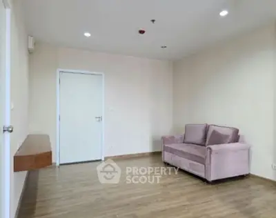 Spacious living room with elegant sofa and wooden flooring