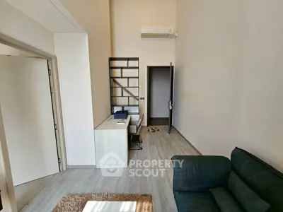 Modern living room with sleek furniture and air conditioning, perfect for urban living.