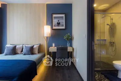 Modern bedroom with ensuite bathroom, stylish decor, and cozy lighting.