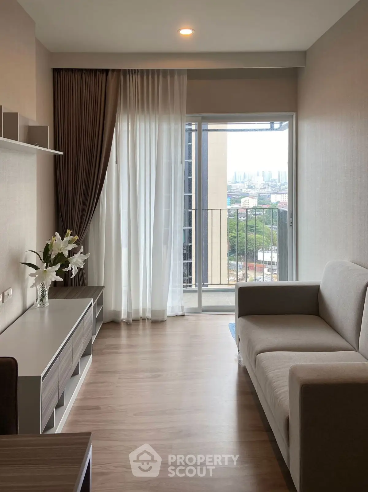 Modern living room with city view and elegant decor in high-rise apartment