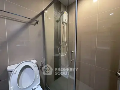Modern bathroom with glass shower enclosure and sleek tile design