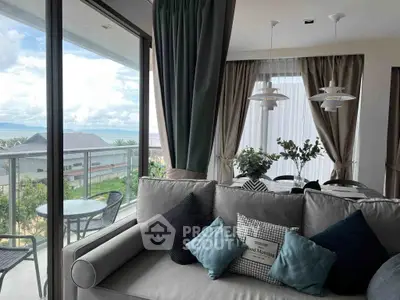 Luxurious living room with ocean view and elegant decor, featuring a spacious balcony.