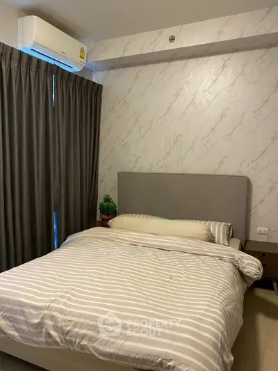 Cozy bedroom with modern decor and air conditioning, perfect for restful nights.
