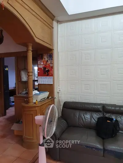 Cozy living room with leather sofa and unique wall paneling