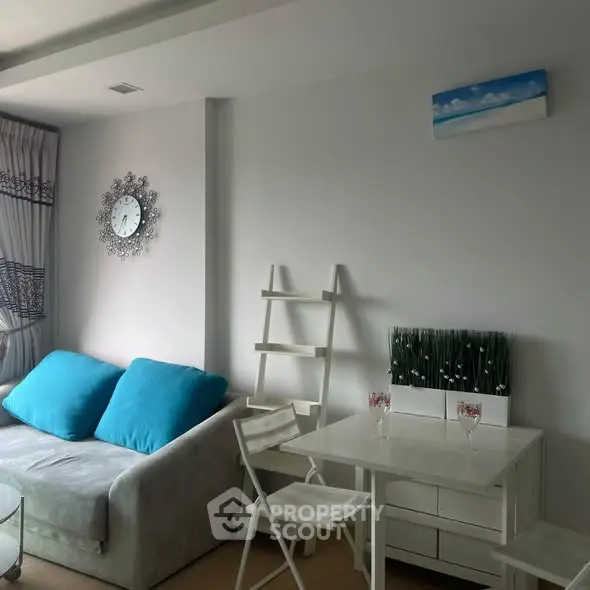Chic modern living room with stylish decor and cozy seating in a bright apartment.