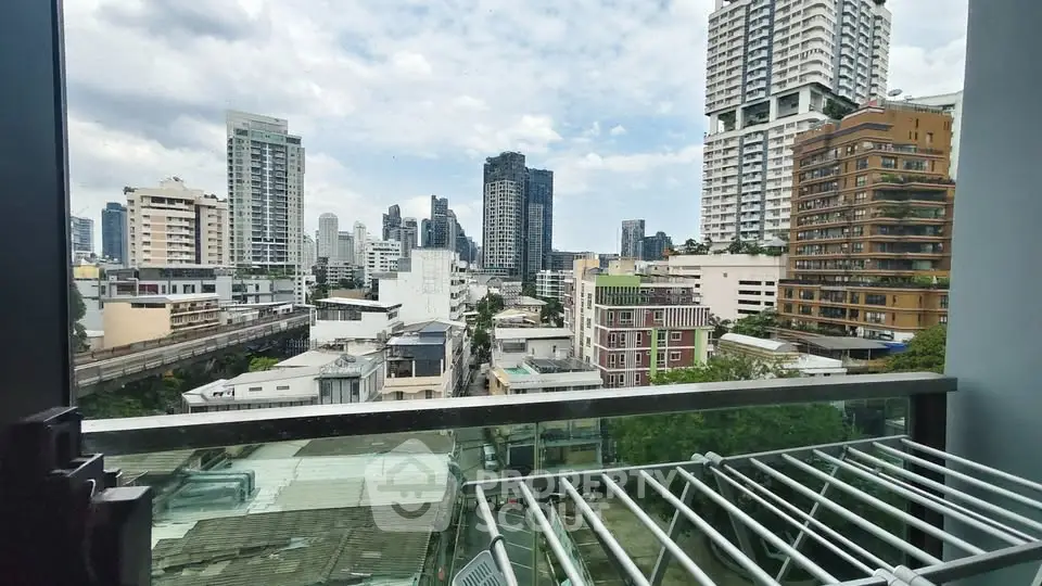 Stunning cityscape view from a modern balcony in a high-rise building, showcasing urban living at its finest.